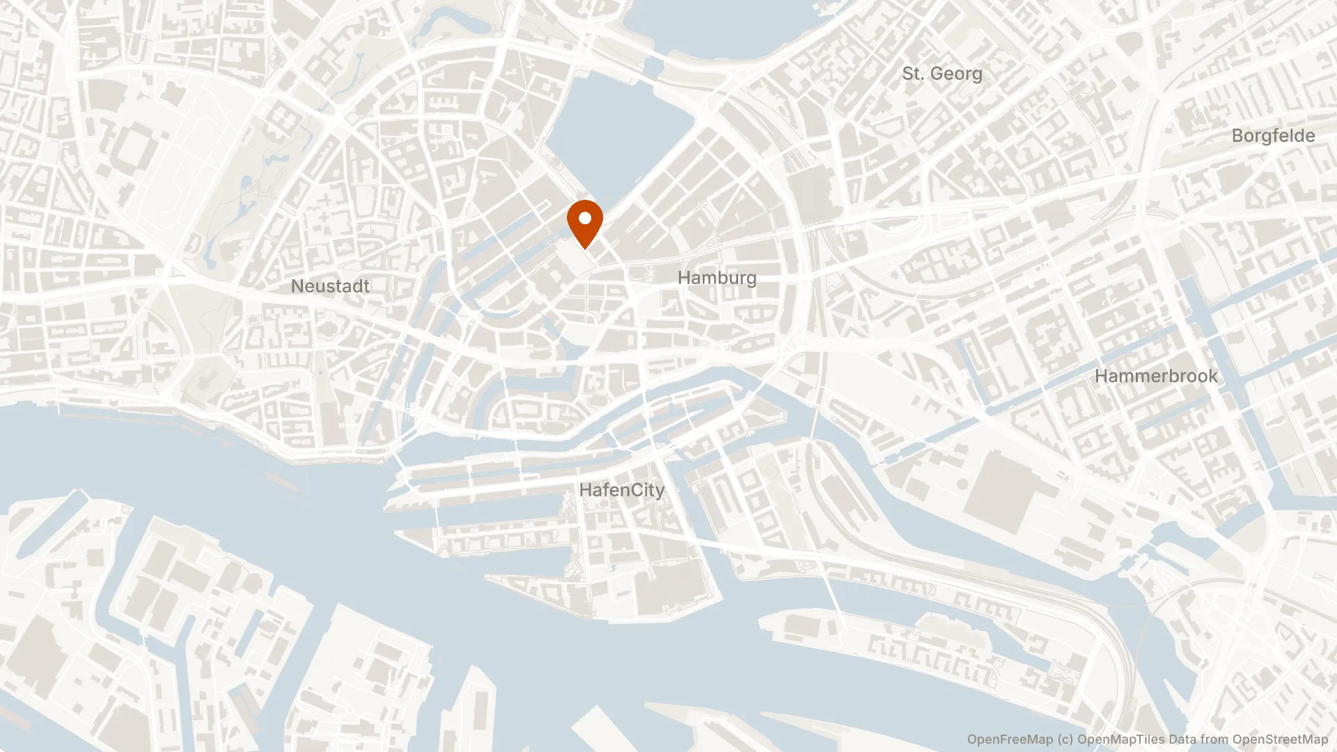 Central Hamburg from the Elbe to St. Georg, rendered by stillmap in a warm off-white palette with an orange marker.