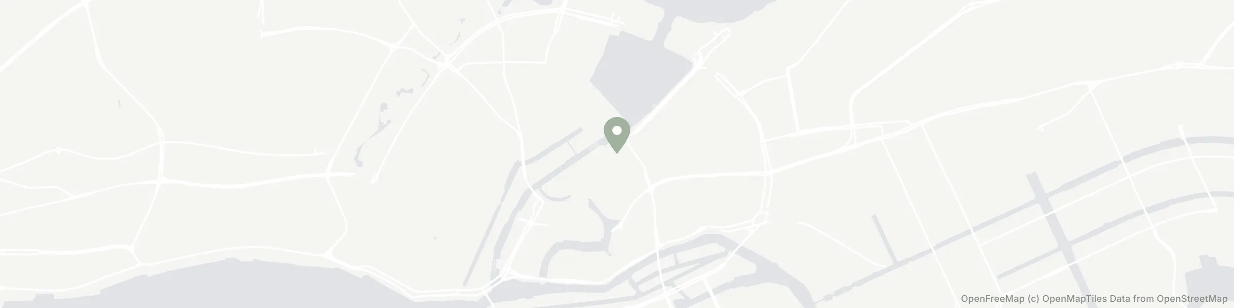 A wide, pale map banner of Hamburg showing only water and two road classes, with a green pin and attribution in the corner.